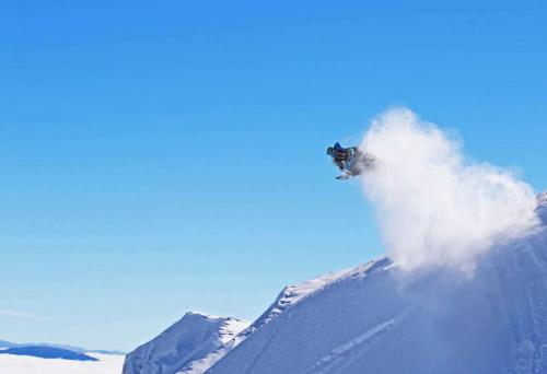 Duncan Lee jumping on snowmobile