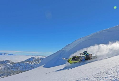 Duncan Lee riding snowmobile in Lake Tahoe